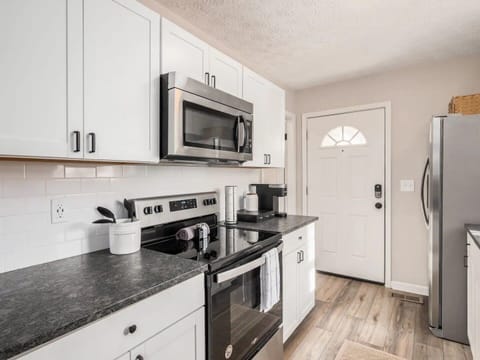 Experience cinematic elegance in this captivating living room, perfect for enjoying your favorite movies Fully equipped kitchen