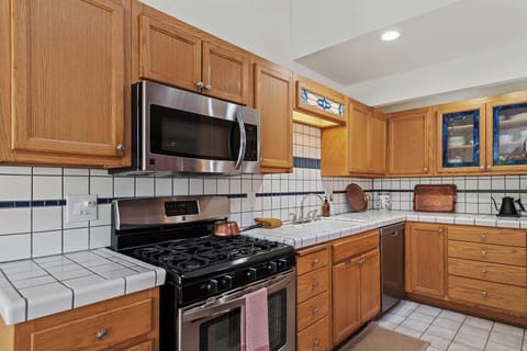 Home chefs will appreciate the gas range and well-stocked kitchen.