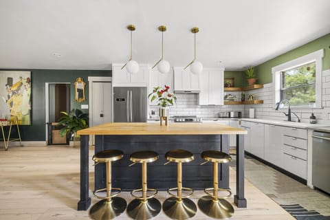 Barstool seating at the island in this gorgeous fully stocked kitchen