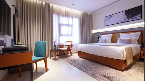 Junior Suite, City View | In-room safe, desk, laptop workspace, blackout drapes