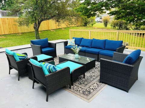 Lots of outdoor furniture on a shady and private back patio.