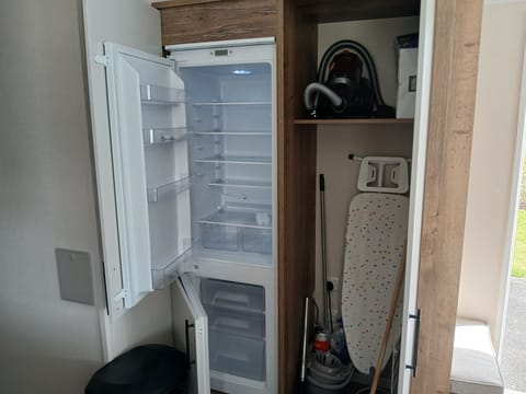 Full size fridge freezer. Iron and ironing board