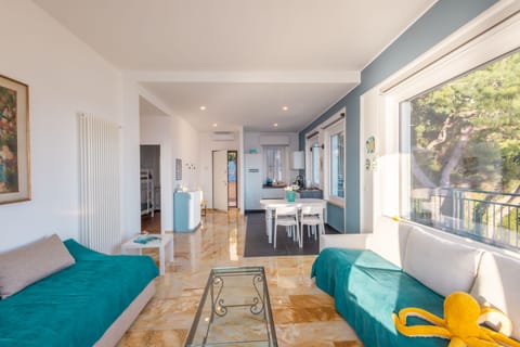 Apartment, Sea View | Living area | 35-inch TV with digital channels