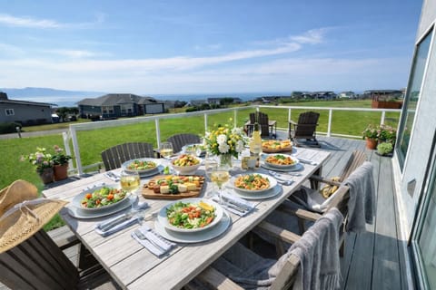Outdoor seating at both a table for dining and adarondacks for enjoying wonders