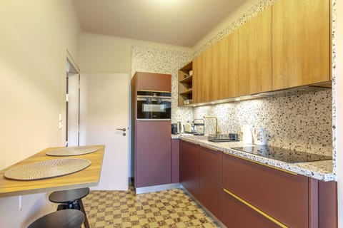 Modern kitchen equipped with high-end appliances, ample counter space, and a cozy breakfast nook. Perfect for preparing delicious meals during your stay.