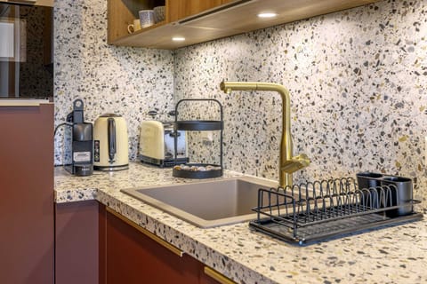 Modern kitchen details with high-end fixtures, including a sleek sink, ample counter space, and all essential appliances for a comfortable stay.