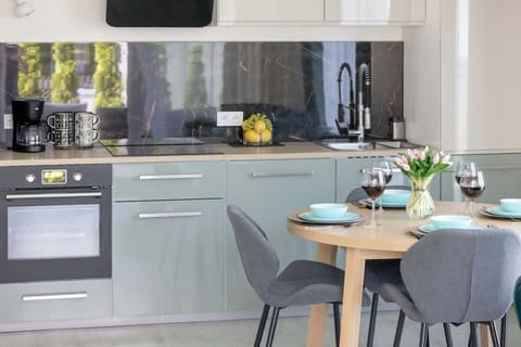 Modern kitchenette with kitchen appliances and dining area.