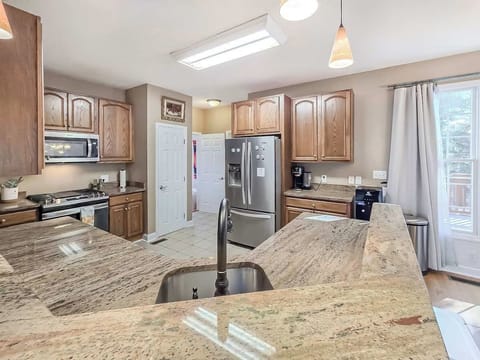 Open kitchen layout with stainless steel appliances