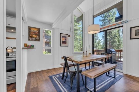 Dining Room: 6-person dining table, soaring windows, access to deck, located between the living room and kitchen