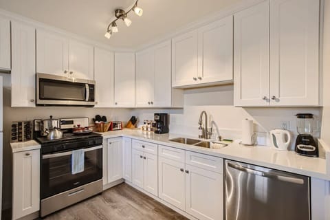 Enjoy the full kitchen and dining area with a refrigerator, freezer, oven, stove, microwave, dishwasher, coffee, creamers, mixers, spices, pots, pans, cooking supplies, cutlery, cups, plates, bowls, utensils, small appliances, and many more essentials.