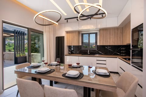 The kitchen also offers an indoor dining table and outdoor access.