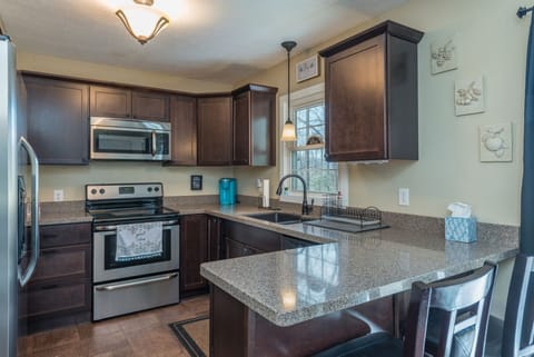 Kitchen equipped with stainless appliances, granite countertops, a dishwasher, and Keurig coffeemaker.