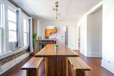 a spacious dining table for leisurely meals and a modern kitchen island for effortless meal prep, a stylish long table and a spacious kitchen island, perfect for hosting memorable meals and fine dining