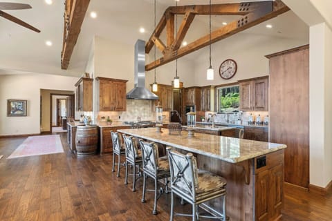 This kitchen's large island is ideal for meal prep and entertaining, blending rustic charm and modern flair.