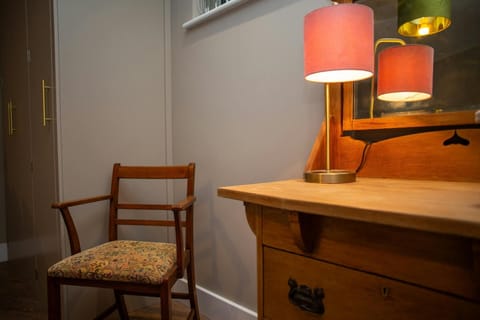 King size bedroom with dressing table, lamp and chair