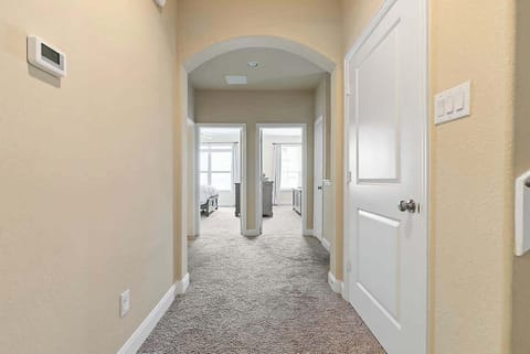 The spacious hallway serves as a seamless transition that divides the bedrooms.