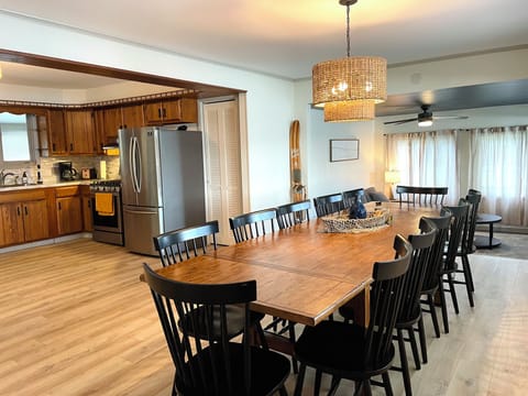 The Waldron Lake Retreat Dining Room: a large dining room table and chairs with a large window to take in the sights of the lake