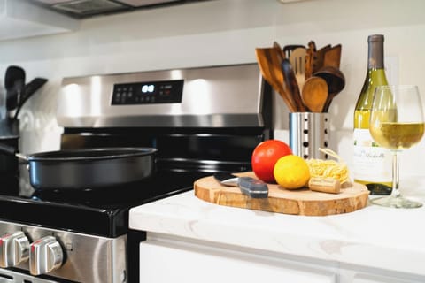 - Cooking essentials ready on modern stove for use  
- Fresh produce and utensils create a homey touch  
- Perfect spot for preparing meals during your stay  
