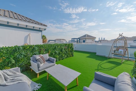 Roof garden with seating, bar area and panoramic sea view