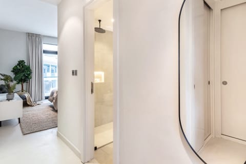 Beautiful Master bedroom with king sized bed, walk through wardrobe area, large ensuite, large Samsung Smart TV and balcony with seating