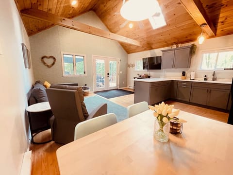 Open floor plan with vaulted ceilings, ceiling fan and gorgeous wood ceiling.