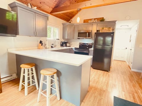 Open floor plan with vaulted ceilings, ceiling fan and gorgeous wood ceiling.