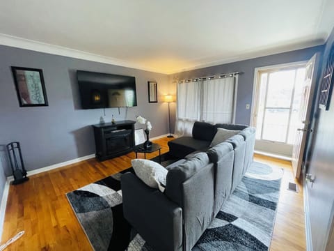 A 65 in TV is mounted on the wall to provide immersive viewing experience.