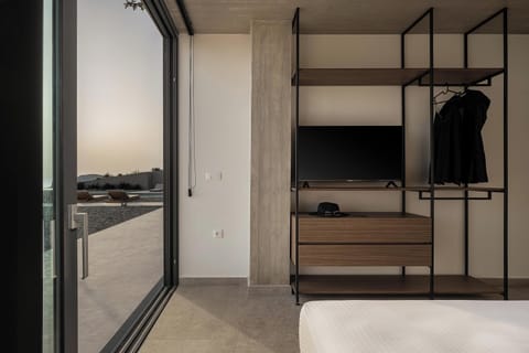 This bedroom also features an en-suite bathroom with a stand-up shower an open closet, a 43” TV, a self-controlled A/C, and direct access to the outdoor area