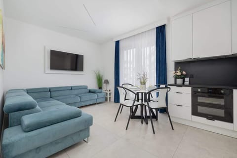 Spacious and bright interior with modern white and turquoise furniture

