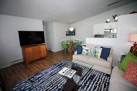 Living room with Smart TV connected to dining/kitchen area