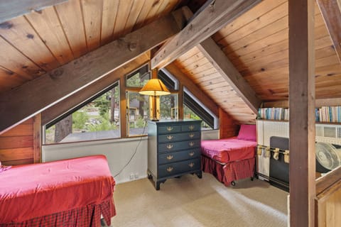Loft with books and twin beds