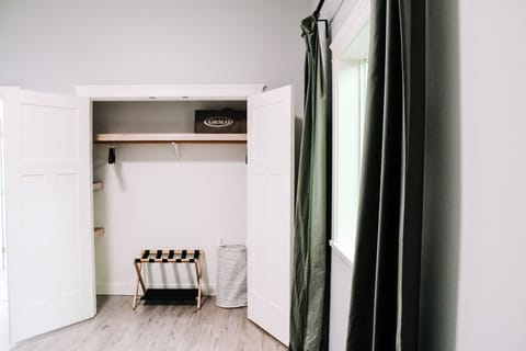 Luggage rack, closet hangers and laundry hamper. Playpen/crib for infants.