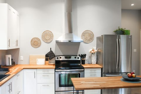 Knife block, cutting boards and hot plates. Stove, pots, pans and bakeware.