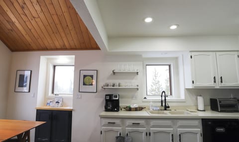 - Kitchen essentials include drip and pod coffee maker, mugs, and glassware - Sink sits under a bright window for dish duty with a view of the treetops - Simple layout makes mornings smooth and clean up easy for all