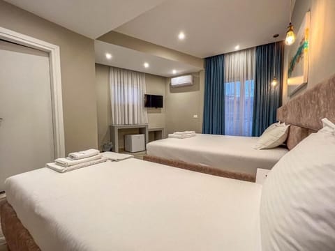 Deluxe Triple Room, Balcony | Desk, free WiFi