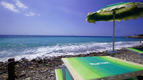 Private beach, black sand, sun loungers, beach umbrellas