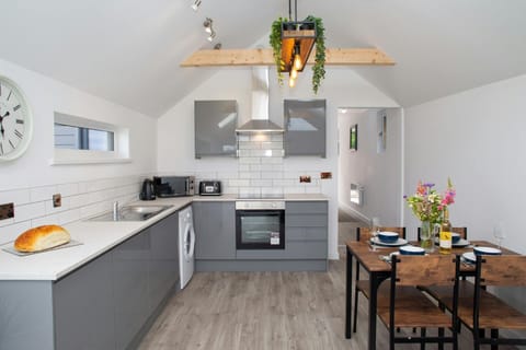 Kitchen area with microwave, electric hob and oven