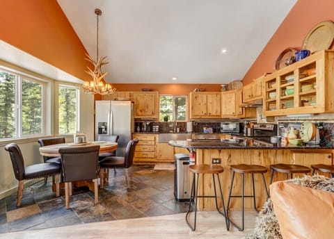 Dine with a view! Our kitchen and dining space opens up to the beauty of the pines, creating the perfect backdrop for your nature feasts.