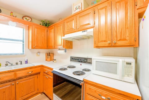 Elevate your cooking space into a warm and inviting haven with beautiful wooden cabinets!