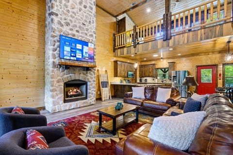 Open concept living/dining/kitchen. 65" smart TV (BYO Login). Gas fireplace