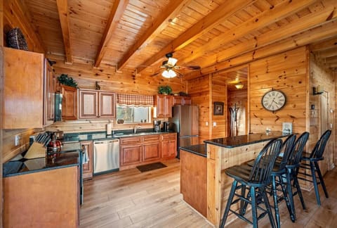 The large kitchen also includes a countertop bar with additional seating for 4.