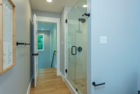 Upper-level bathroom with walk-in shower and hallway access