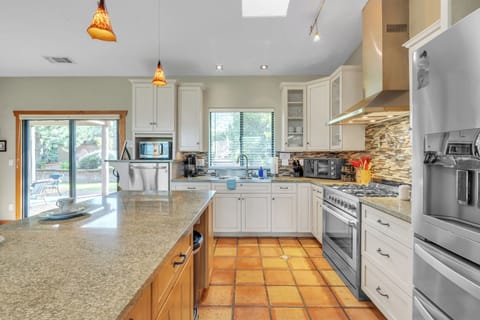 Fully equipped kitchen with high-end stainless steel appliances and ample counter space