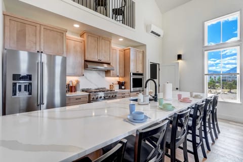 Step into our gourmet kitchen, featuring high-end appliances and a spacious island perfect for meal preparation and casual dining.