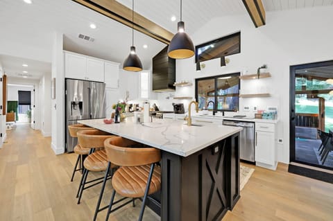 The open concept chef's kitchen keeps the cook in the conversation.