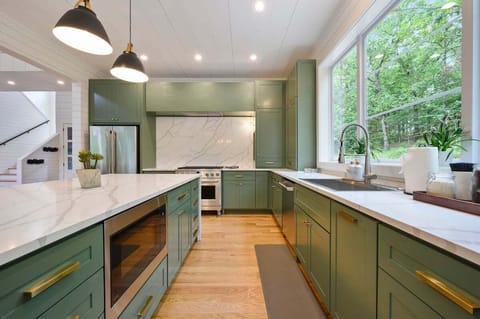 Fully stocked kitchen with gas stove top, microwave, dishwasher, oven, refrigerator, and freezer