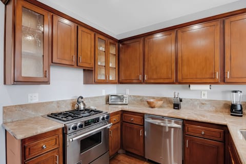 Kitchen is fully equipped and features stainless steel appliances.