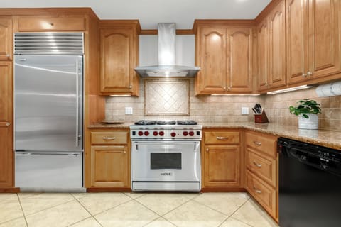 A fully equipped kitchen with instant pot, blender, and pots and pans.