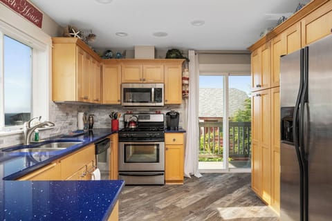 Equipped kitchen with beautiful counters and stainless steel appliances.