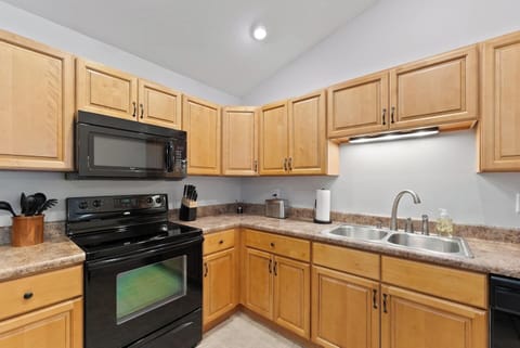 Kitchen comes equipped with a w/Keurig coffee maker, electric stove, and a large fridge. It has all the tools you need for making breakfast, lunch, and dinner!